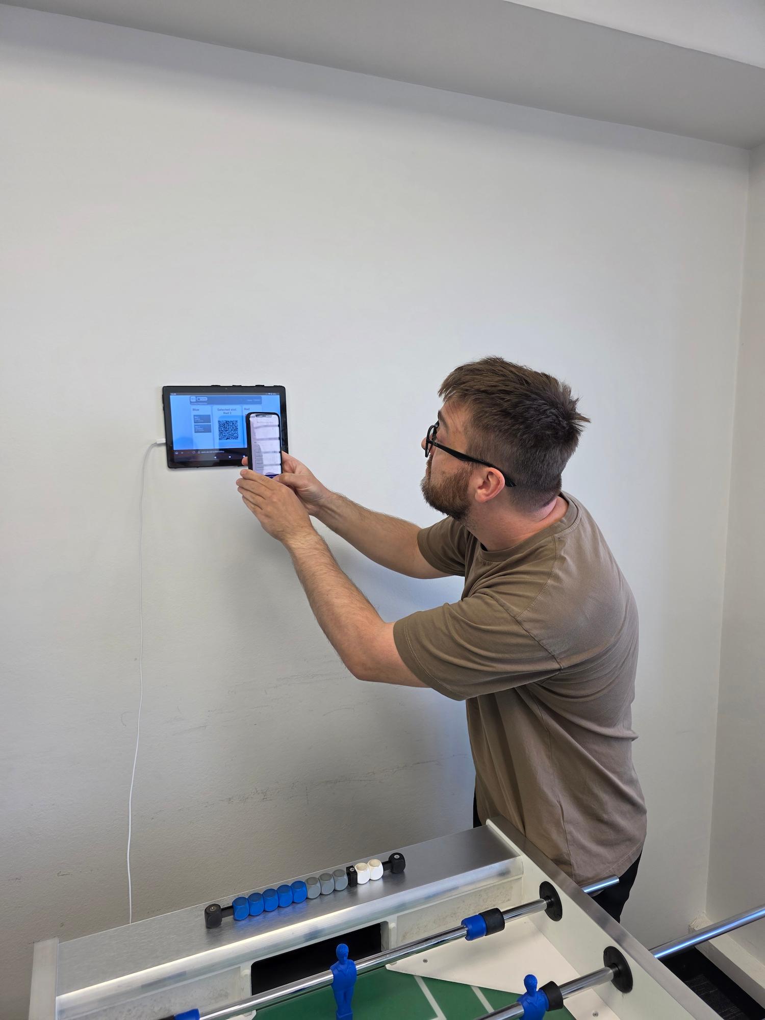 Image depicts a player scanning a
QR code to register for the match.